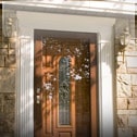 A home entryway with a wood and glass front door.