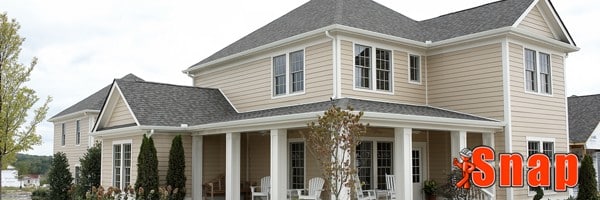 A large home with beige vinyl siding.