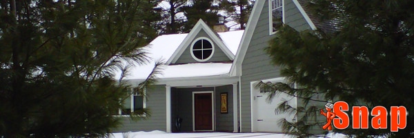 A home with snow on it with engineered wood siding.
