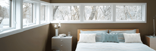 A set of awning windows in a bedroom.