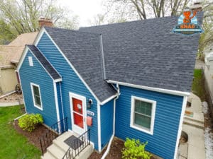 Home with blue siding and gray shingle roof.