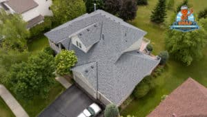 Top view of a large house with asphalt shingle roofing