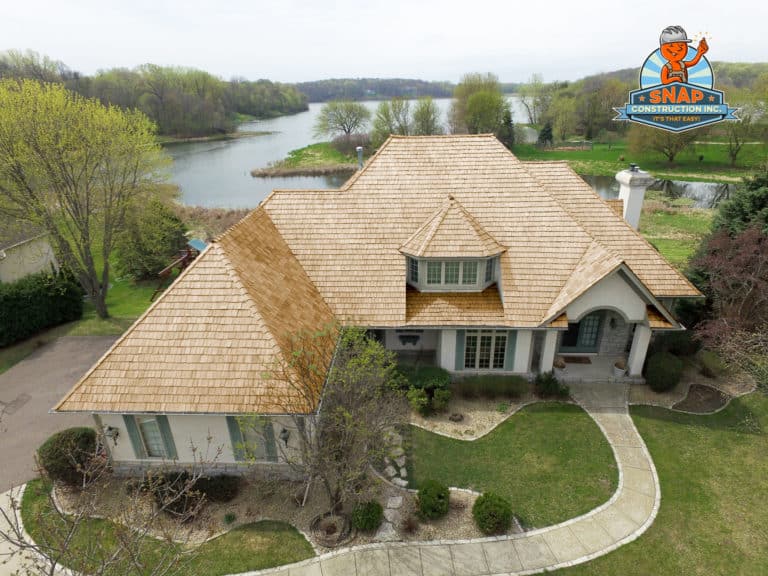 A large single-family home has wood shake roofing.