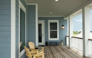 The front porch of a home with blue siding