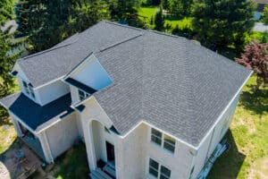 Aerial view of a luxury home with asphalt shingle roofing