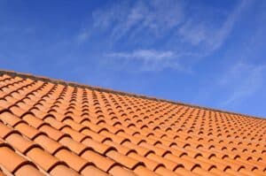 Close-up of a tiled roof with blue sky in the background