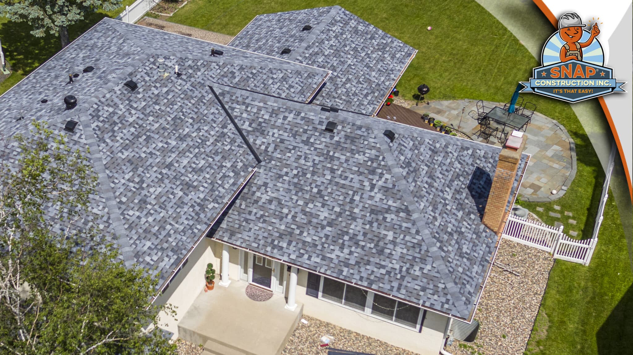 Aerial view of asphalt shingle roof replacement in Bloomington MN by Snap Construction, showing gray roofing on a suburban home