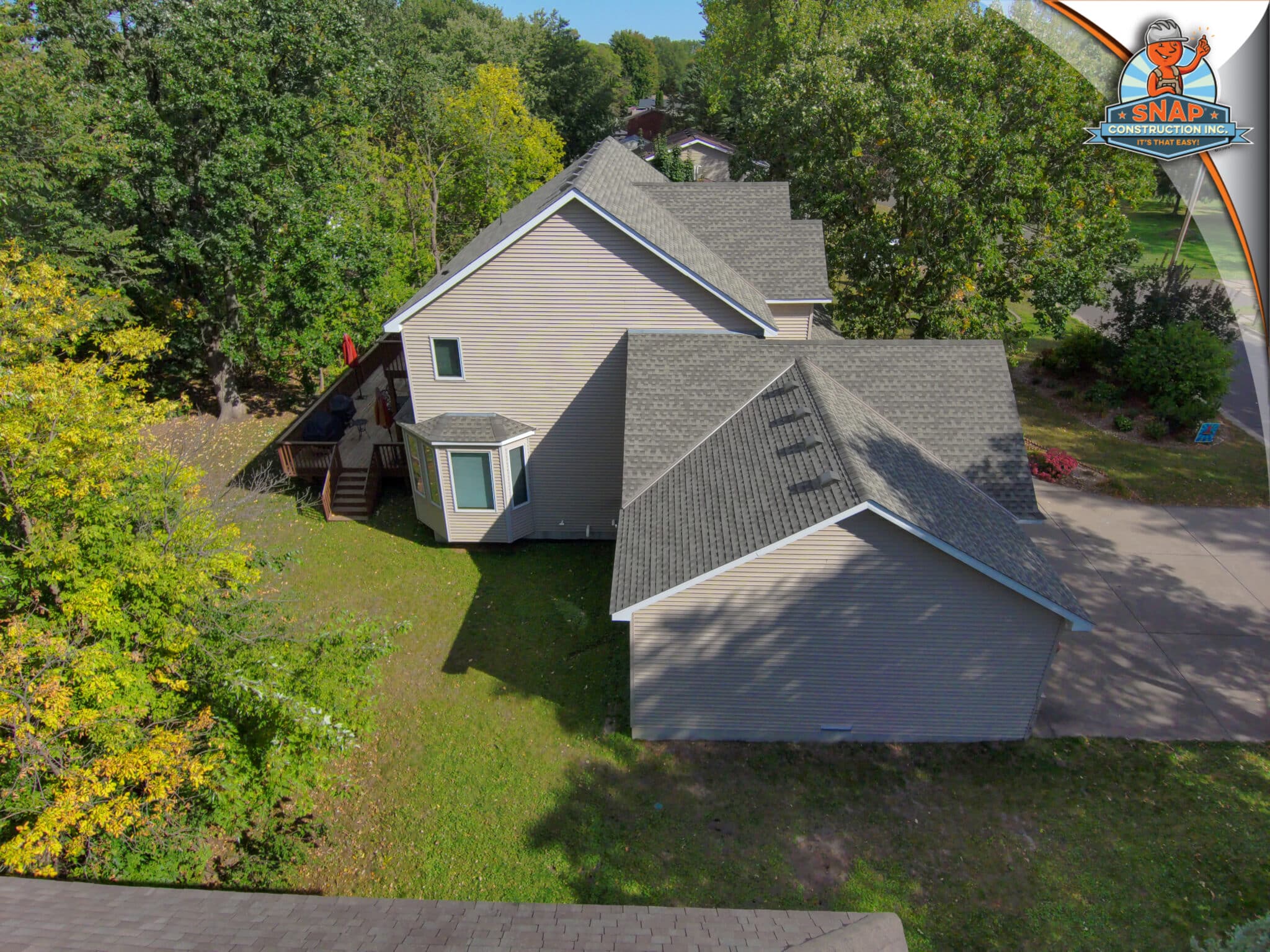 Aerial view of brown asphalt shingle roof, driveway and patio by Snap Construction, Local Roofing Company serving Bloomington MN