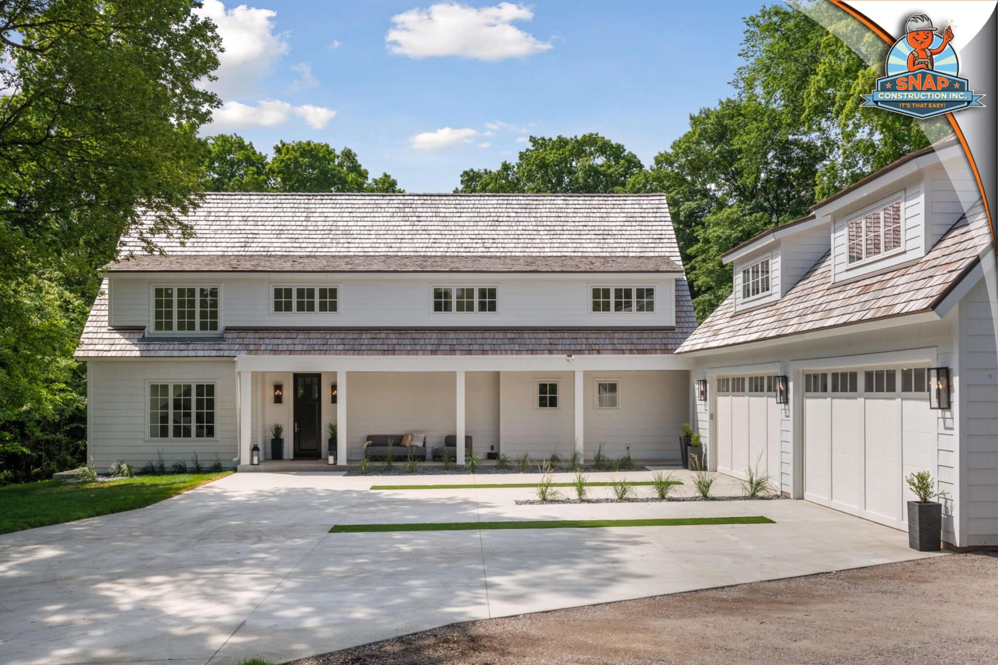 Roofing contractor near me in Bloomington MN, Snap Construction, featuring a cedar shake roof on a modern white home with three-car garage
