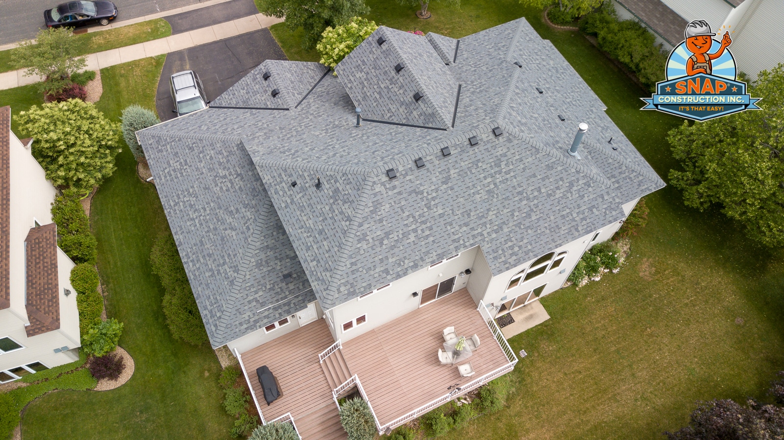 Aerial view of gray shingle roof with Owens Corning roofing installed by Snap Construction in Bloomington MN showing complex multi-hip design